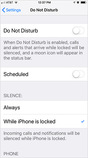 Dette er et skjermbilde av iOS Do Not Disturb-innstillingene. Det første alternativet er å slå Ikke forstyrr på eller av. I dette skjermbildet er innstillingen av. Under innstillingen er teksten “When Do Not Disturb er aktivert, samtaler og varsler som kommer mens de er låst vil være stille, og et måneikon vises i statuslinjen. ” Under dette alternativet er alternativet Planlagt, som er slått på av. Deretter vises to alternativer for stillhet: Alltid eller mens iPhone er låst. I dette skjermbildet er Mens iPhone er låst valgt, og følgende tekst vises “Innkommende anrop og varsler vil være stille mens iPhone er låst. ” Todd Bergin slår på Ikke forstyrr og still alltid meldinger mens han streamer på Instagram Live video.